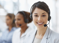 Closeup of a call center employee with headset at workplace