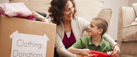 Caucasian grandmother and granddaughter donating clothing
