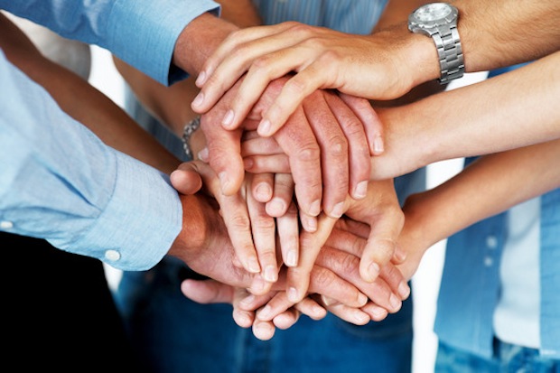 Closeup of a business colleagues with their hands stacked together